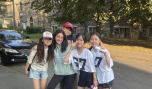 Students smiling while saying goodbye, capturing friendship and warm memories from their study abroad experience.