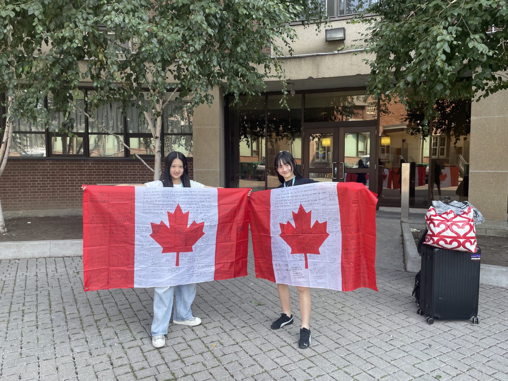 Junior study abroad participant with Canadian flag full of messages